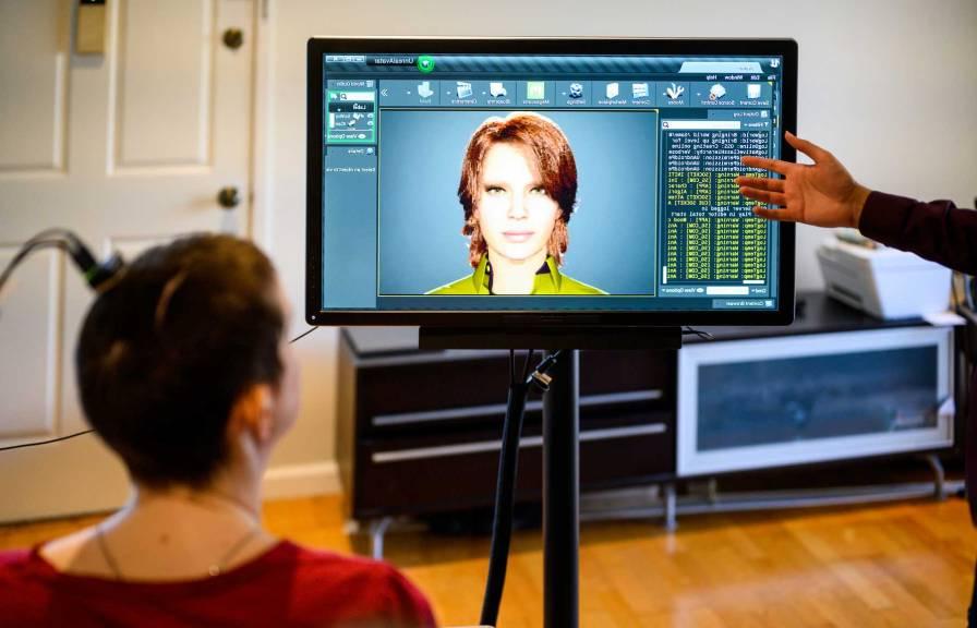 Computer screen with a woman in front with brain implant.